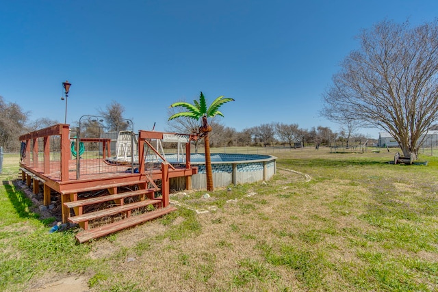 view of yard featuring an outdoor pool and a deck