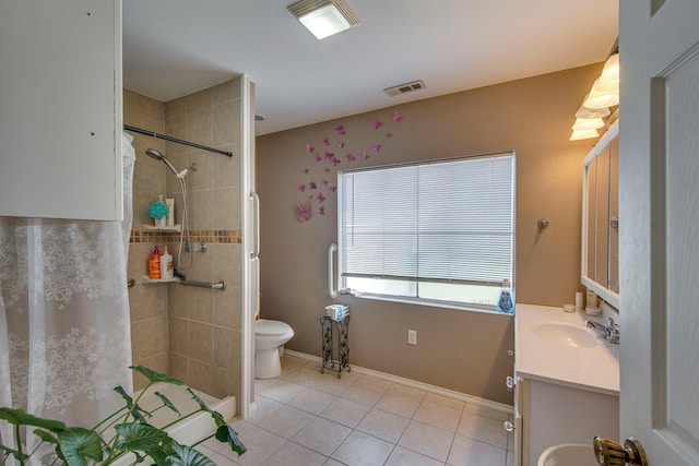 full bath with tile patterned flooring, visible vents, toilet, tiled shower, and vanity