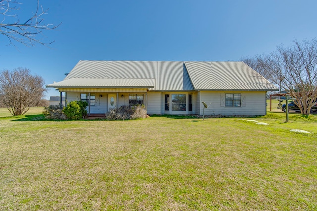 view of front of property with a front lawn and metal roof