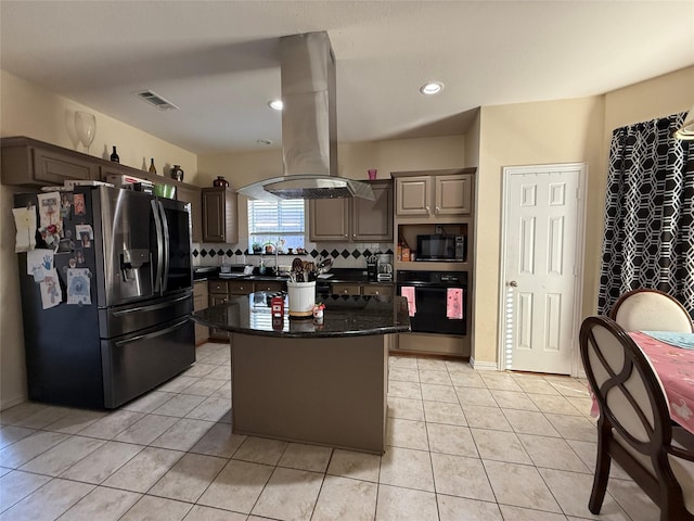 kitchen with visible vents, black appliances, island exhaust hood, backsplash, and light tile patterned flooring