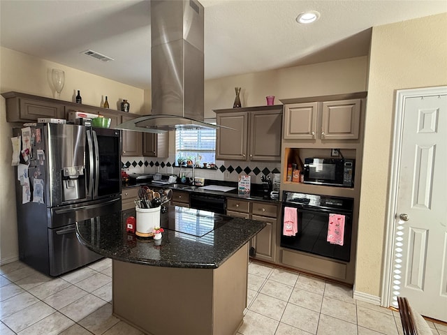 kitchen featuring black appliances, light tile patterned floors, visible vents, and island range hood