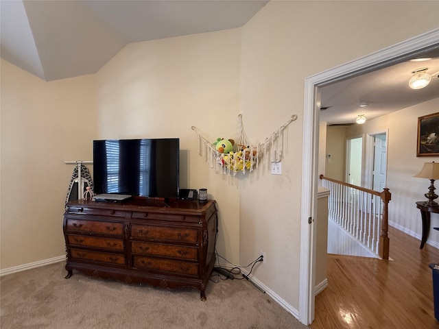 interior space featuring vaulted ceiling and baseboards