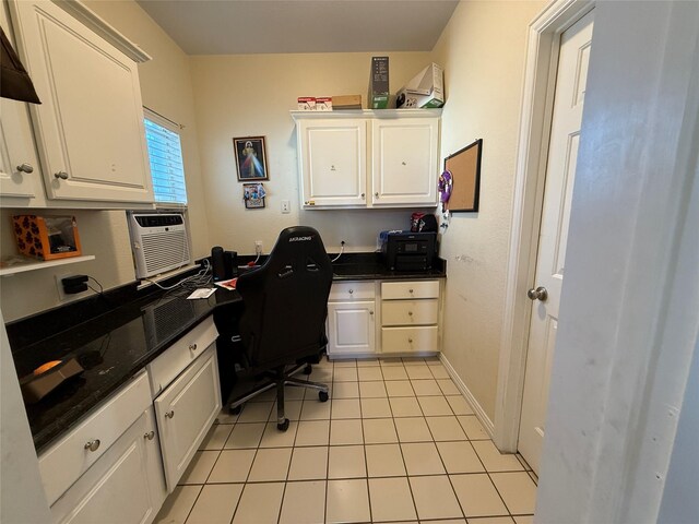 home office with light tile patterned flooring and baseboards