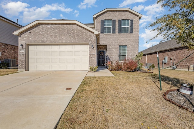 traditional-style house with central AC, concrete driveway, a front yard, an attached garage, and brick siding