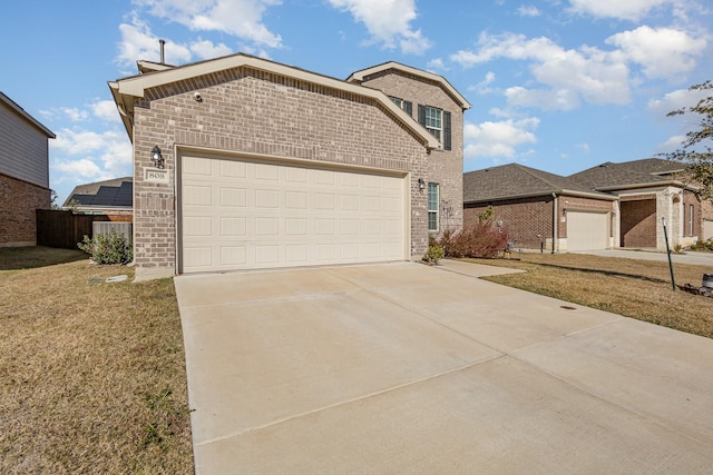 view of front of property with a front yard, fence, driveway, a garage, and brick siding