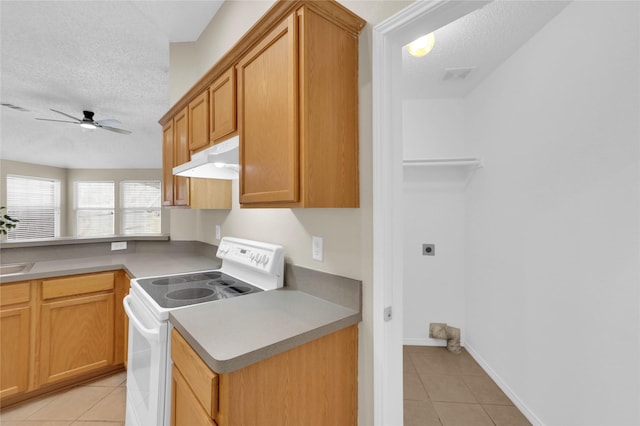 kitchen featuring ceiling fan, light tile patterned floors, under cabinet range hood, and white electric stove