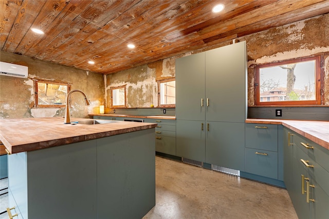 kitchen featuring a sink, wooden counters, wooden ceiling, and a wall mounted AC