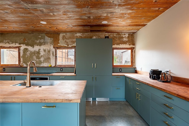 kitchen featuring butcher block counters, wooden ceiling, and a sink