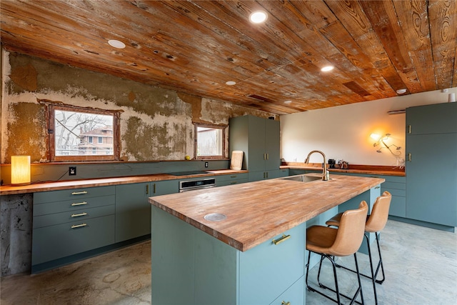 kitchen with a center island with sink, a sink, wooden ceiling, butcher block counters, and green cabinetry