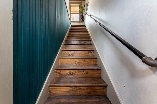 staircase with a textured wall