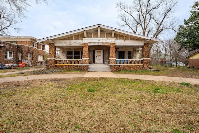 view of front of home with a porch and a front yard