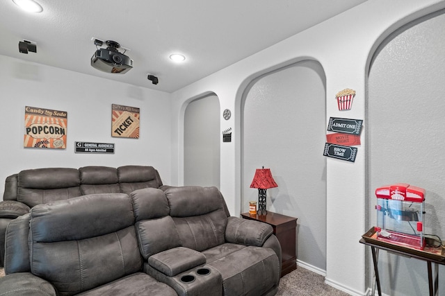 carpeted home theater featuring recessed lighting, baseboards, and arched walkways