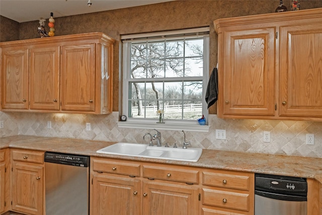 kitchen featuring stainless steel dishwasher, light countertops, decorative backsplash, and a sink