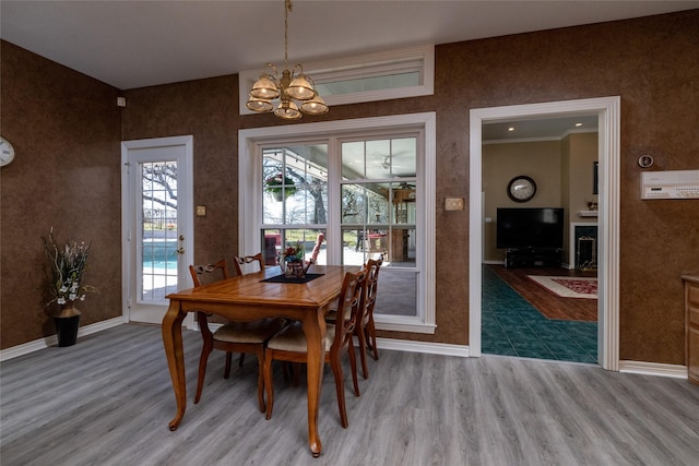 dining area featuring a healthy amount of sunlight, baseboards, and wood finished floors