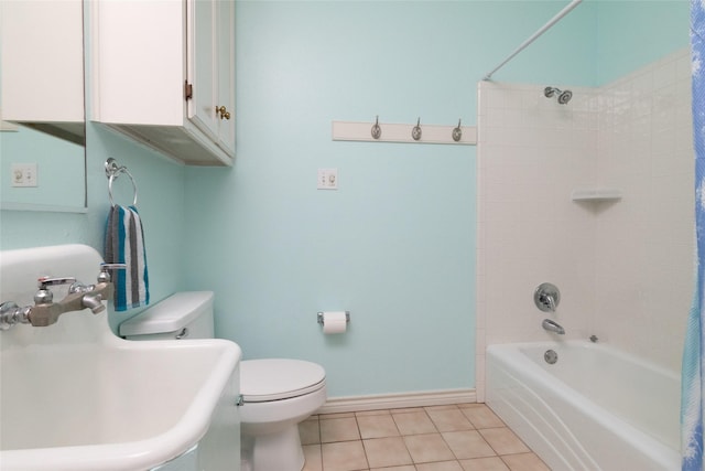 bathroom with baseboards, a sink, shower / tub combo, tile patterned floors, and toilet