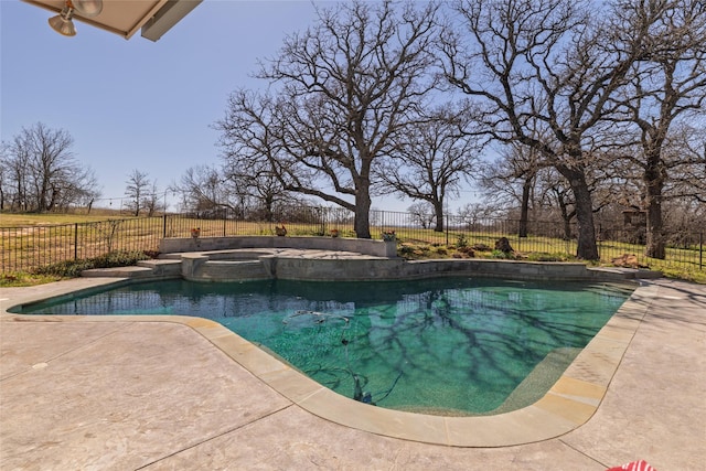 view of swimming pool with a patio, a fenced backyard, and a pool with connected hot tub