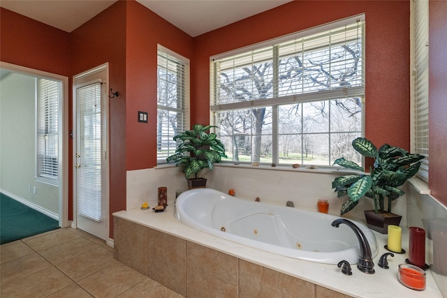 full bath with tile patterned floors and a jetted tub