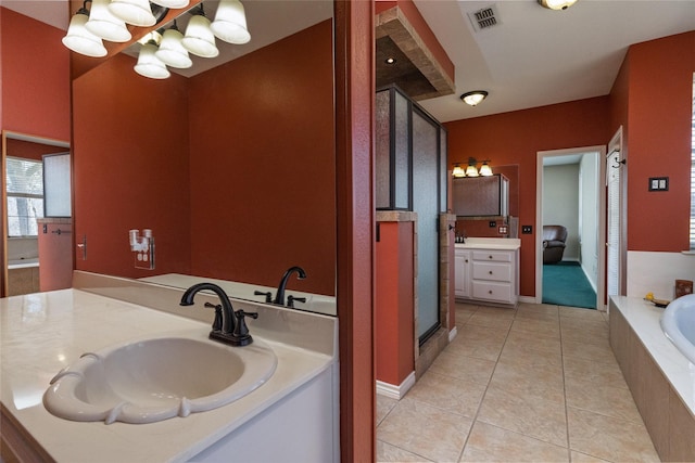 bathroom with tile patterned flooring, visible vents, a garden tub, a stall shower, and vanity