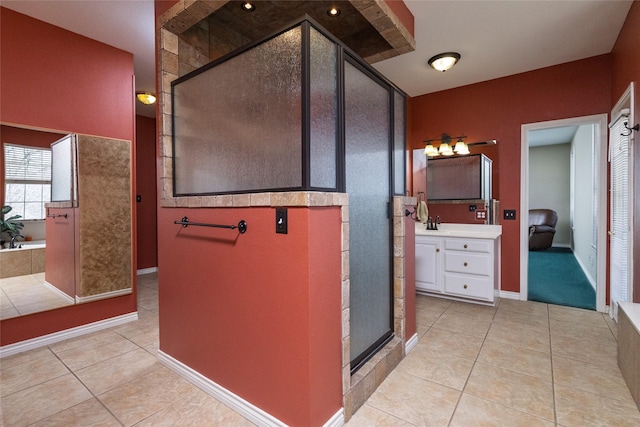 bathroom with tile patterned floors, a stall shower, vanity, and a bath