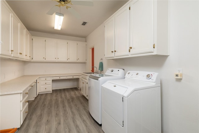 laundry room featuring visible vents, washer and dryer, light wood-style floors, cabinet space, and a ceiling fan