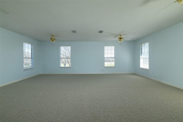 unfurnished room with visible vents, light colored carpet, and baseboards