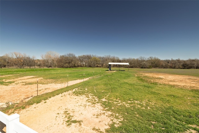 view of yard with a rural view