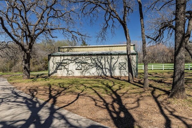 view of outbuilding with an outbuilding and fence