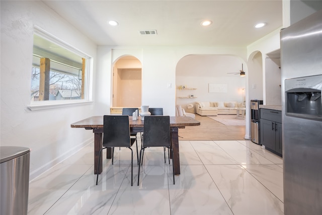 dining space with visible vents, baseboards, recessed lighting, arched walkways, and marble finish floor