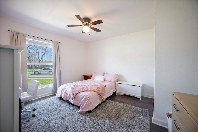 bedroom with baseboards, dark wood-style flooring, and ceiling fan