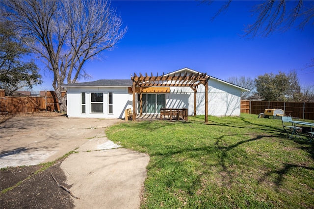 back of house featuring a patio, a lawn, a fenced backyard, and a pergola