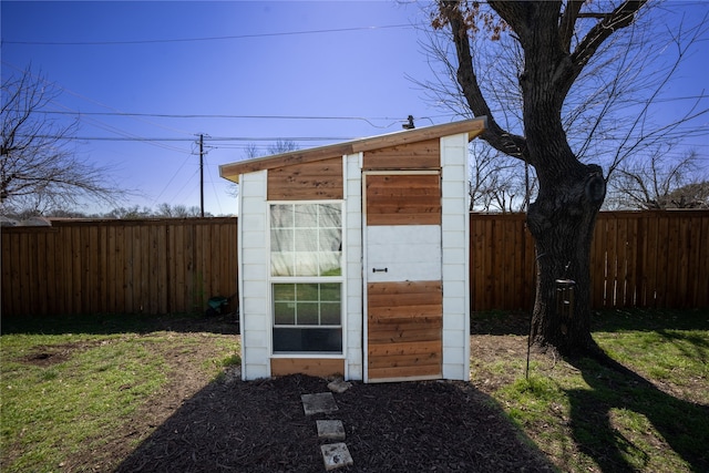 view of shed with a fenced backyard