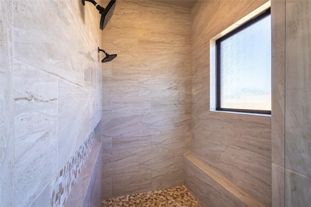 bathroom with a tile shower