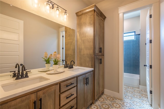 bathroom featuring a sink, baseboards, and double vanity