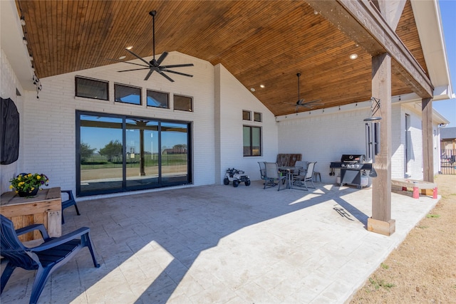 view of patio with a grill, outdoor dining area, and a ceiling fan