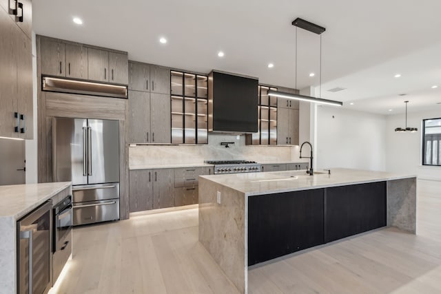 kitchen with beverage cooler, high quality fridge, a large island, and modern cabinets