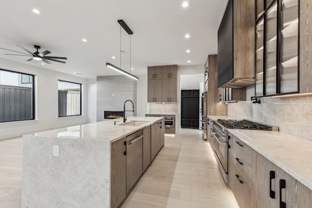 kitchen featuring modern cabinets, a sink, custom exhaust hood, high end appliances, and ceiling fan