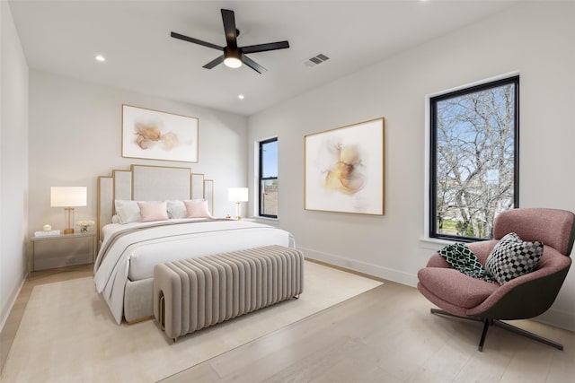 bedroom with recessed lighting, light wood-type flooring, baseboards, and visible vents