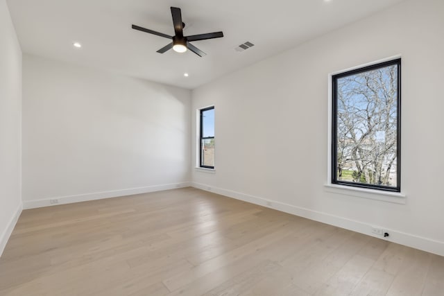 spare room with recessed lighting, a ceiling fan, baseboards, and light wood finished floors