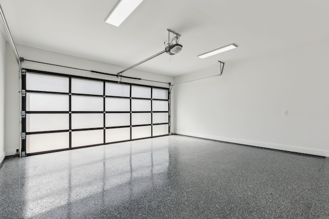 garage with a garage door opener and baseboards