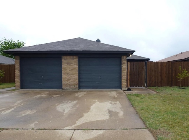 detached garage featuring fence