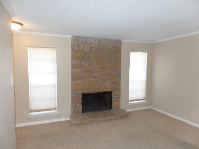 unfurnished living room featuring a fireplace, crown molding, and carpet