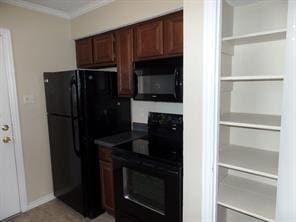 kitchen with baseboards, dark countertops, black appliances, and crown molding