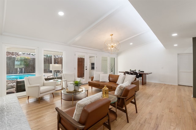 living room with recessed lighting, french doors, a notable chandelier, and light wood finished floors