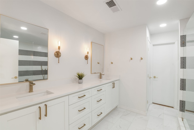 full bath featuring visible vents, marble finish floor, tiled shower, and a sink