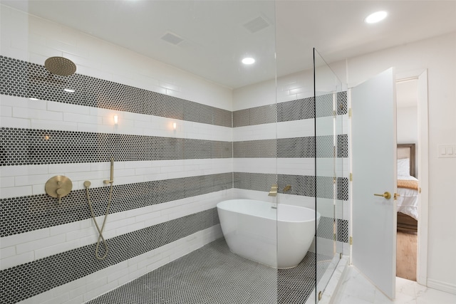 full bath featuring tiled shower, ensuite bath, recessed lighting, a freestanding bath, and marble finish floor