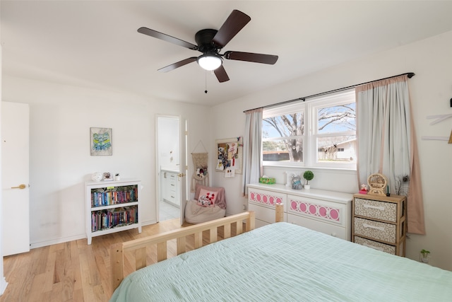 bedroom featuring a ceiling fan, baseboards, light wood finished floors, and connected bathroom