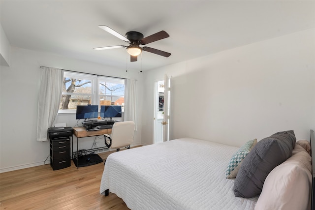 bedroom featuring light wood finished floors, a ceiling fan, and baseboards