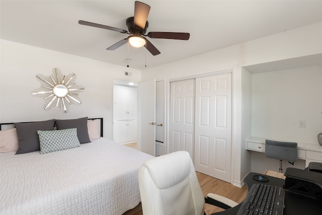 bedroom featuring a ceiling fan, wood finished floors, a closet, and baseboards