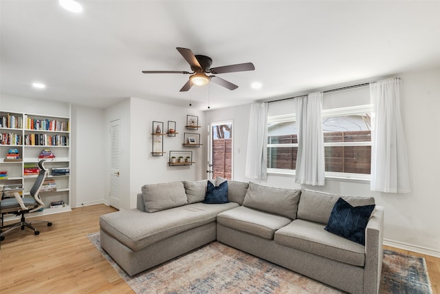 living room featuring recessed lighting, baseboards, a ceiling fan, and light wood finished floors