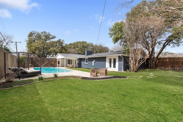 exterior space featuring french doors, a patio, a fenced in pool, and a fenced backyard